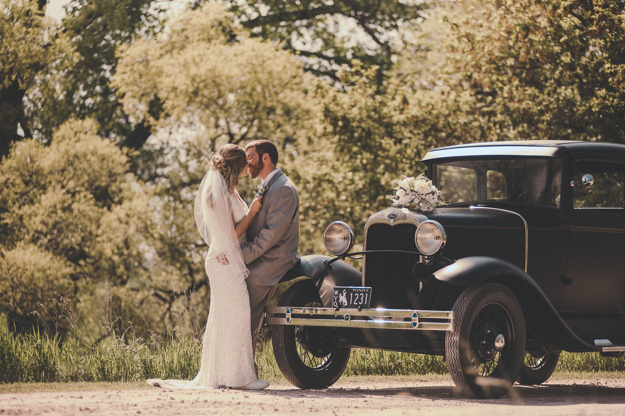 Newcastle WY wedding couple posed on a vintage car