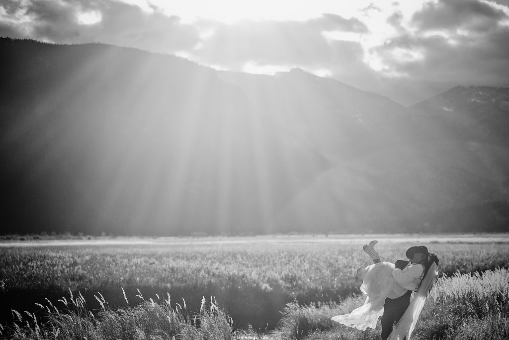 Epic mountain wedding photos of a couple dancing in Wyoming