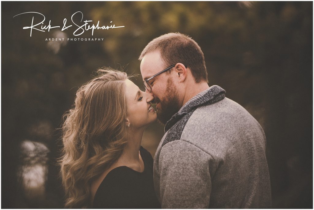Sweet couple during their engagement session share a kiss. This photo was taken during their Wyoming engagement photo session.