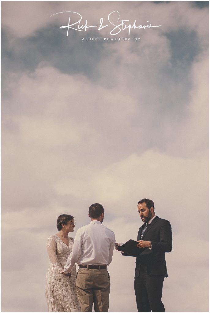 Wedding couple looking at their officiant during their Wyoming wedding and Vedauwoo elopement.