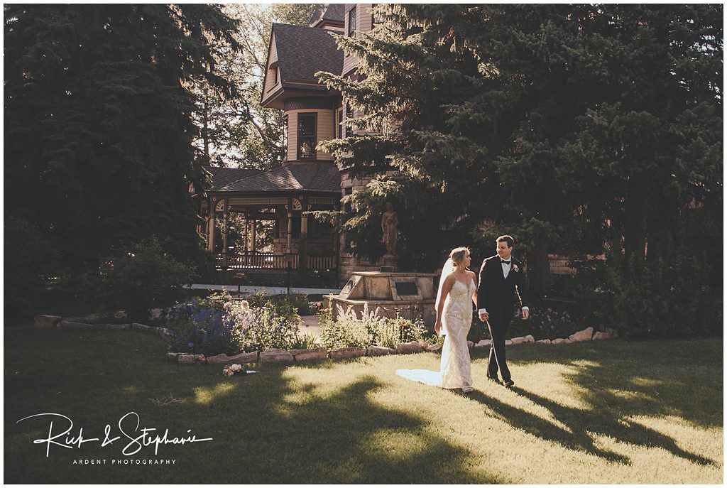 Ivinson Mansion wedding photo of the bride and groom walking through the garden.