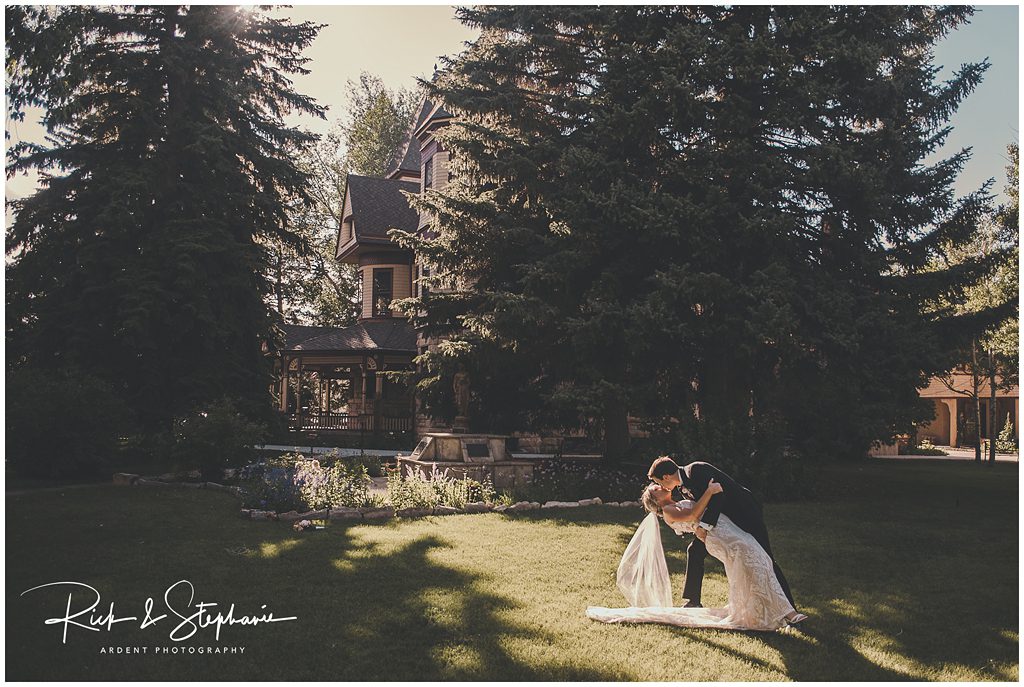 Ivinson Mansion wedding photo of the groom dipping the bride in the garden of the mansion.